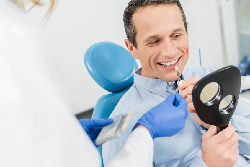 Male patient choosing tooth implants