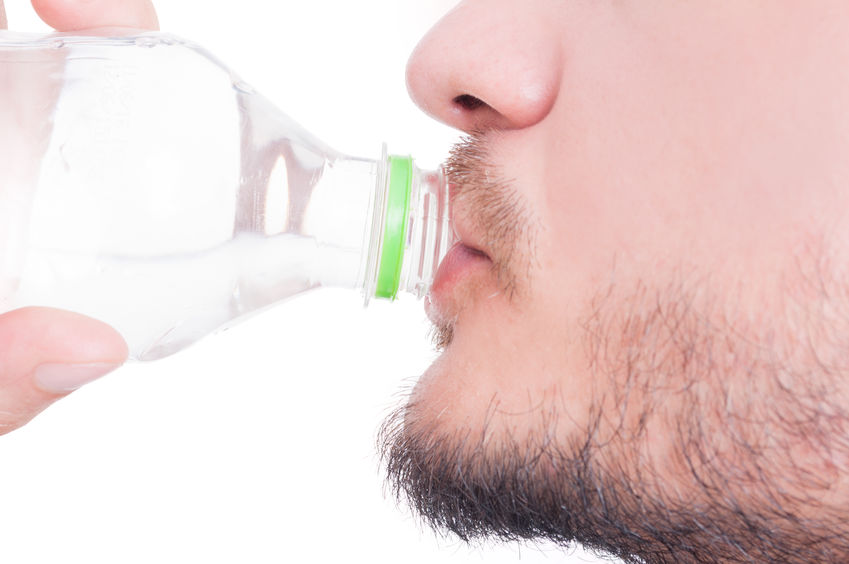 Close up with male mouth drinking water on white background